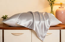 Silver Grey silk pillowcase on a made bed