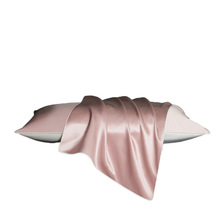 Blush Rose silk pillowcase draped over a pillow, studio white background